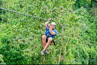 A Man Zip Lining Sitting Down Los Canones Canopy Tour La Fortuna
 - Costa Rica